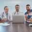 healthcare talent team at a hospital looking and discussing information on a laptop