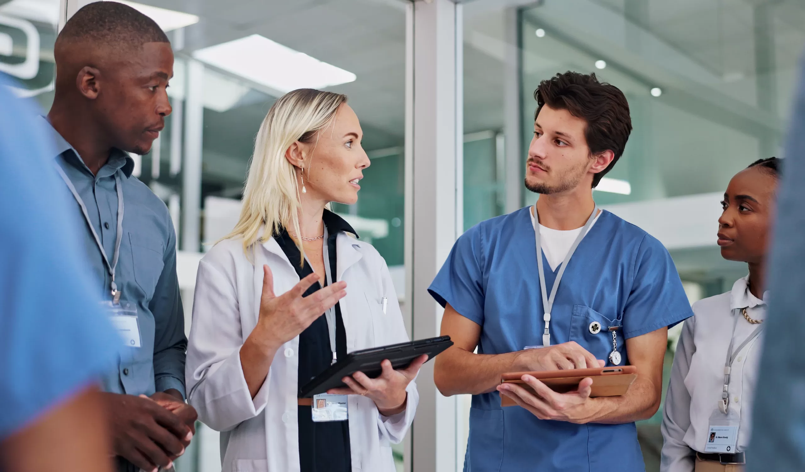 A group of doctors discuss a serious healthcare recruiting topic in a medical facility and hospital.
