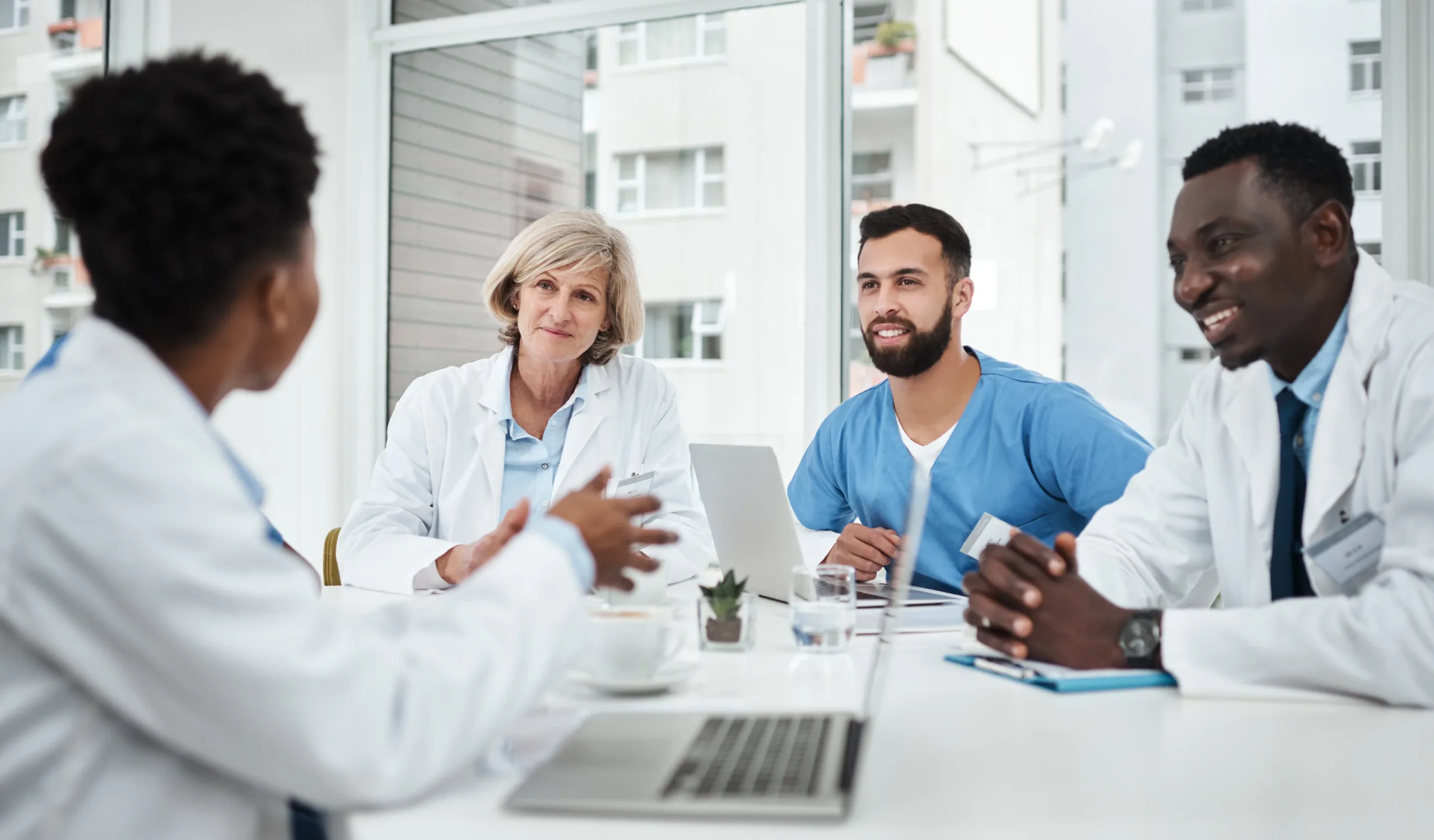 a team of healthcare professionals talk about how to solve medical and staffing challenges